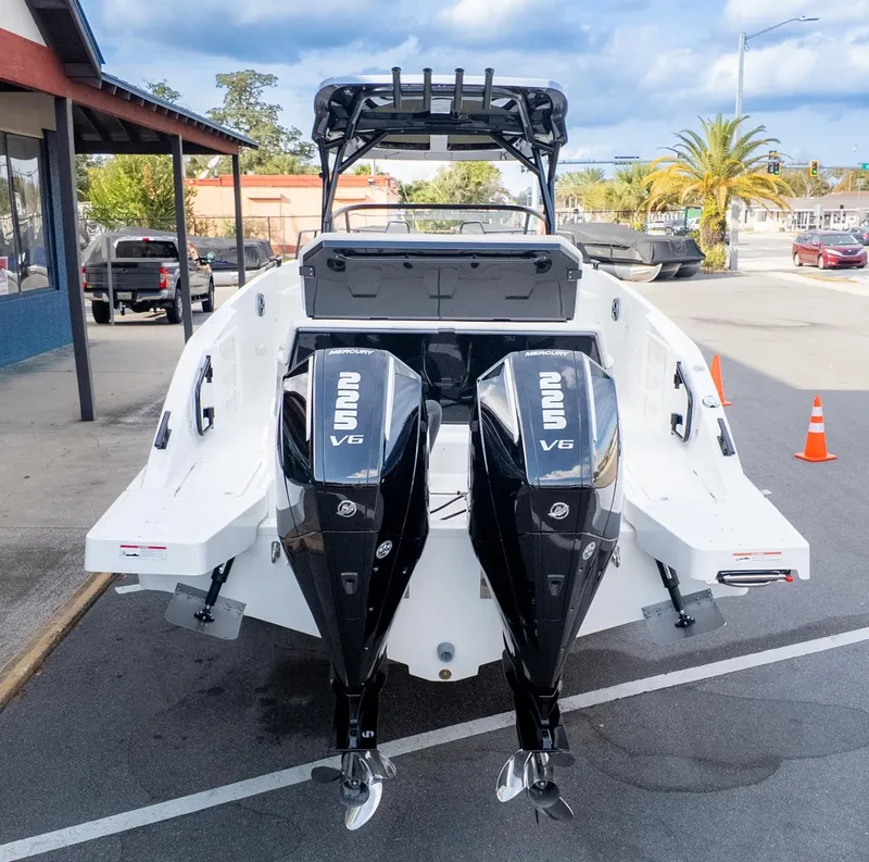 Slide: The Image of The image shows a modern boat with two powerful outboard engines, parked in a lot. - 4