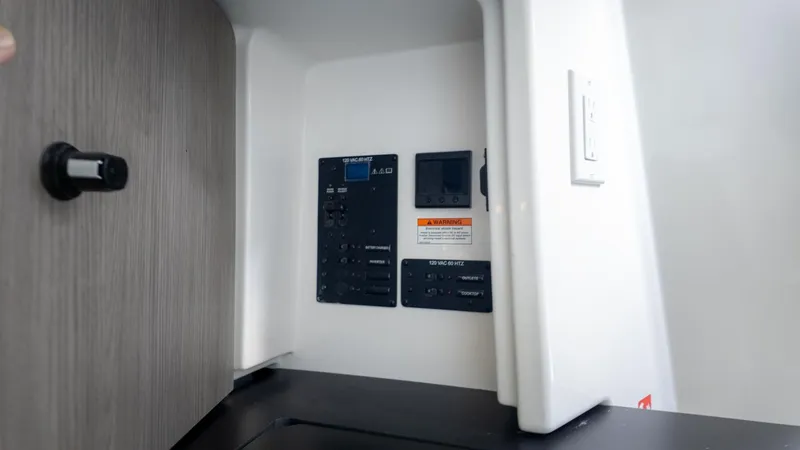 Slide: The Image of Electronic panel inside a boat with switches and displays. - 36
