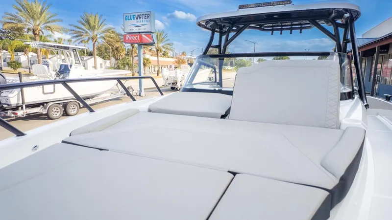 Slide: The Image of The image shows a modern boat with a large, cushioned outdoor lounging area. - 14