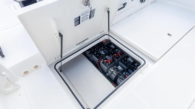 Slide: The Image of View of a boat's open battery compartment lid with multiple batteries inside. - 18