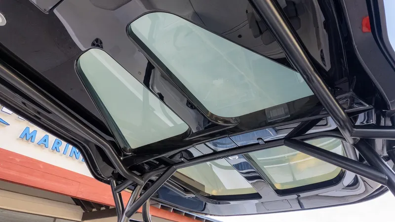 Slide: The Image of The image shows a boat's roof with large glass windows and a sturdy frame. - 24