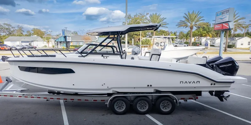 Slide: The Image of A modern motorboat on a trailer, featuring a sleek white hull and a covered helm station. - 5