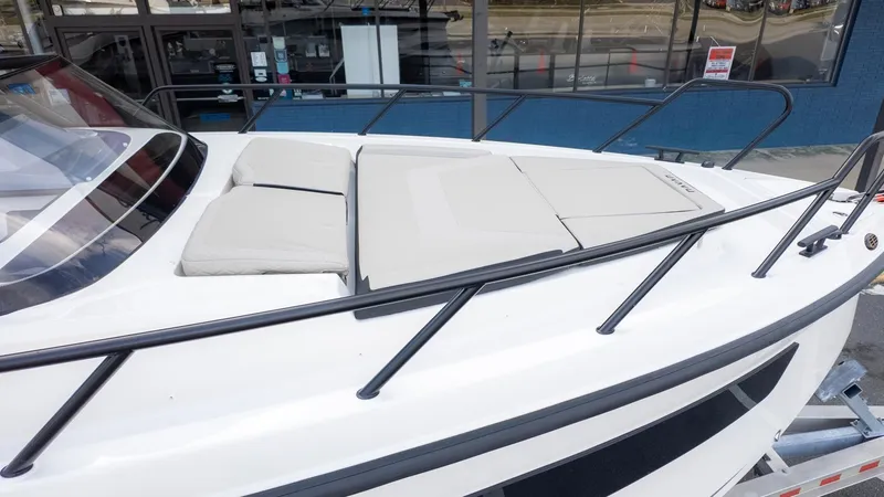 Slide: The Image of The image shows the foredeck of a Navan S30 boat with beige cushions. - 11