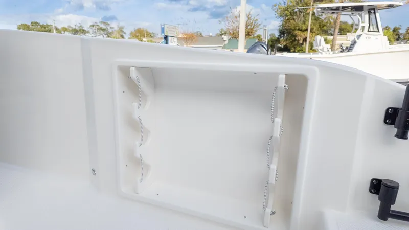 Slide: The Image of An open storage compartment on a modern boat, surrounded by other boats in the harbor. - 14