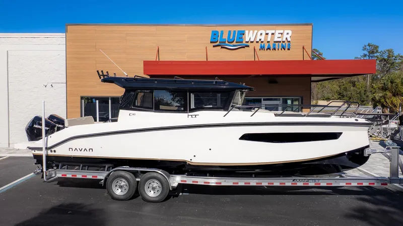 Slide: The Image of A 2026 Navan C30 boat on a trailer in front of a building. - 38