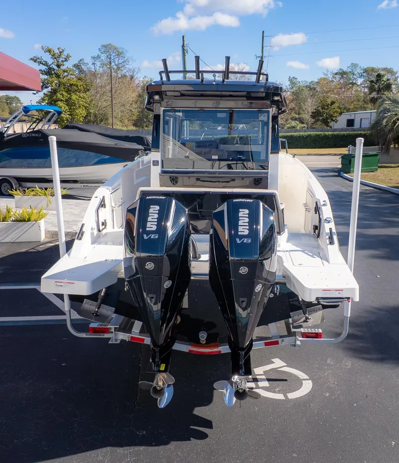 Slide: The Image of The image shows a boat with two outboard engines in a parking lot. - 4