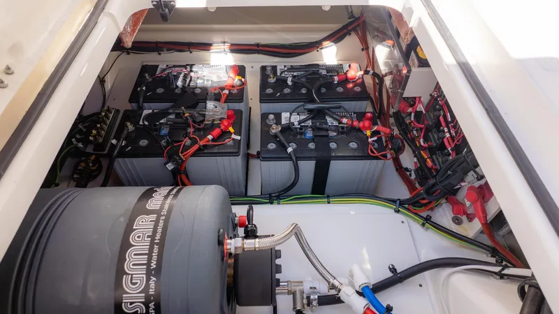 Slide: The Image of View of a boat's engine compartment with multiple batteries and wiring. - 14