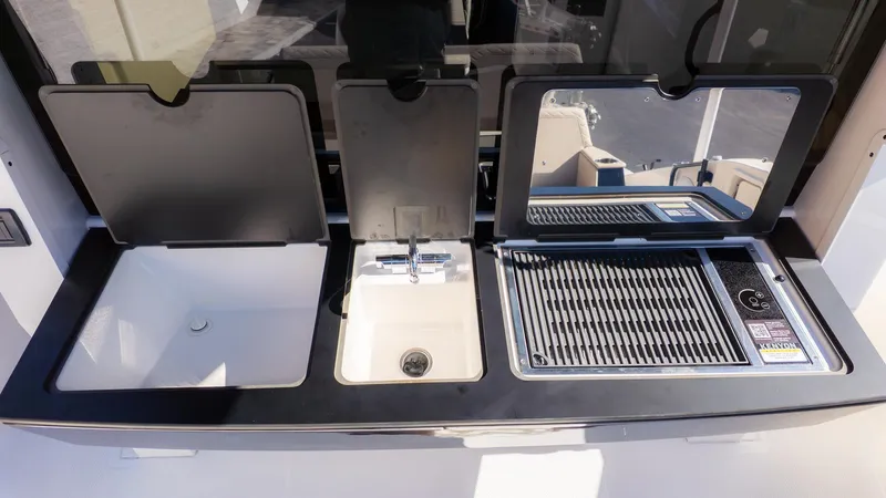 Slide: The Image of The 2026 Navan C30 features a modern outdoor kitchen with a sink and grill. - 9