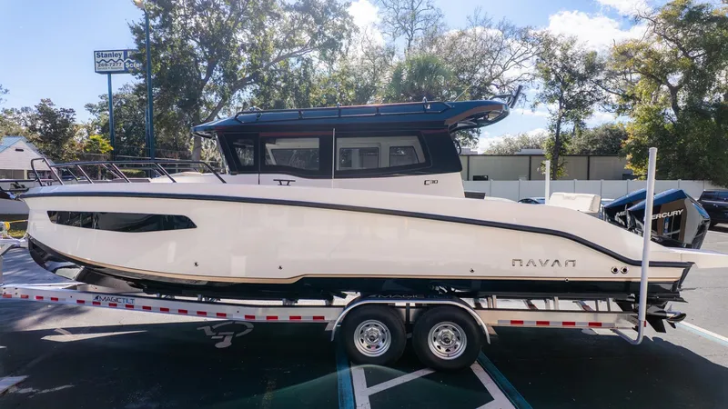 The Image of A modern boat on a trailer, featuring a sleek white hull and black roof. - 1
