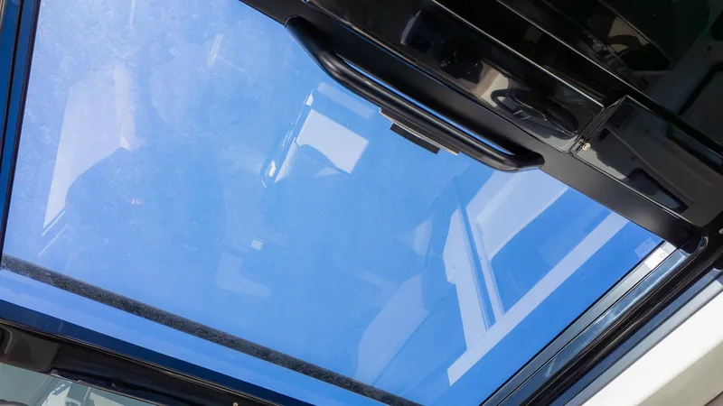 Slide: The Image of View through a glass roof with blue sky in the background. - 26