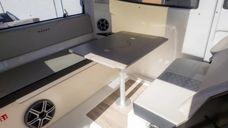 Slide: The Image of Interior of a 2026 Navan C30 with a table and seating benches. - 16