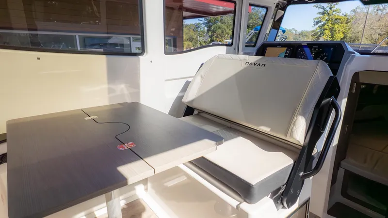 Slide: The Image of Interior of a 2026 Navan C30 with a table and bench seating. - 17