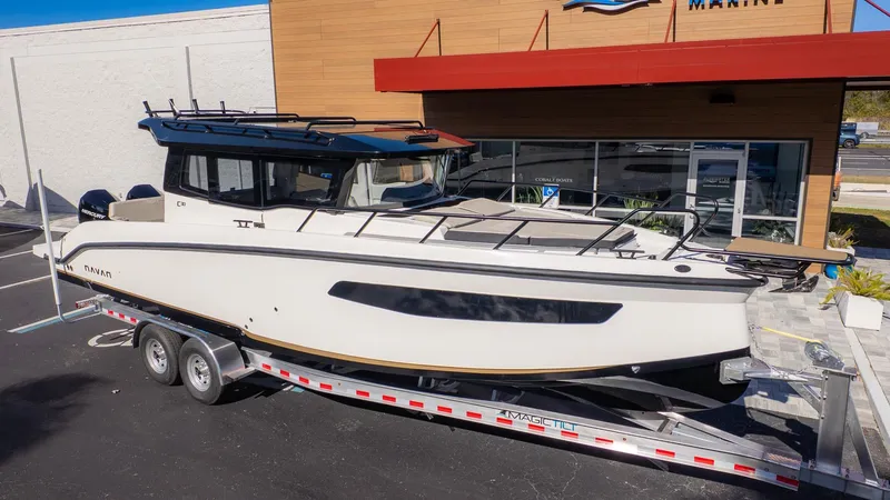 Slide: The Image of A modern boat on a trailer in front of a building. - 38