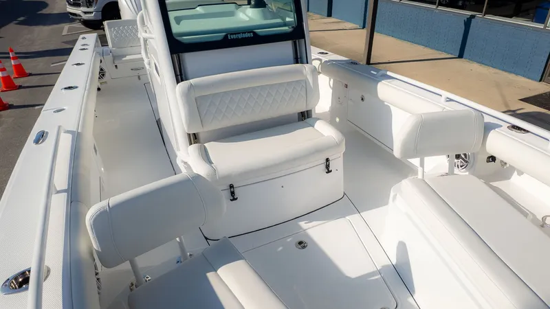 Slide: The Image of The image shows the cockpit of a 2027 Everglades 273 Center Console boat with white seating. - 11