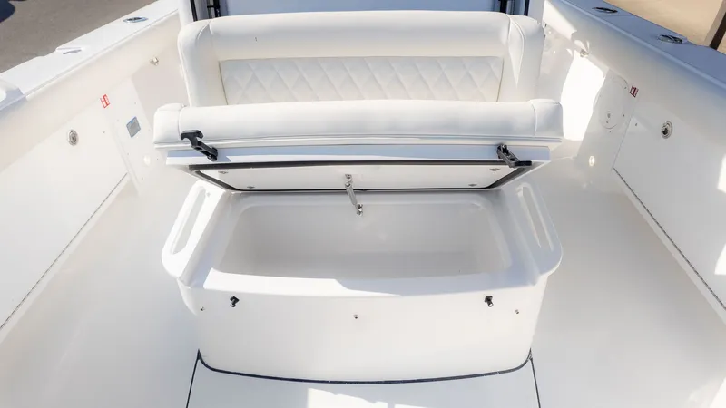 Slide: The Image of The image shows a white bench seat with storage underneath on a boat. - 27