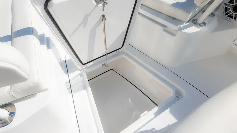 Slide: The Image of An open storage compartment on a 2027 Everglades 273 Center Console boat. - 26