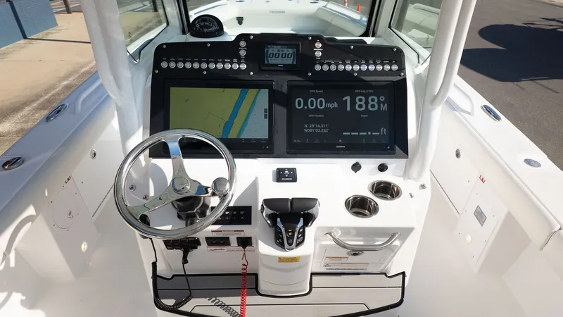 Slide: The Image of The image shows the helm of a 2027 Everglades 273 Center Console boat. - 17