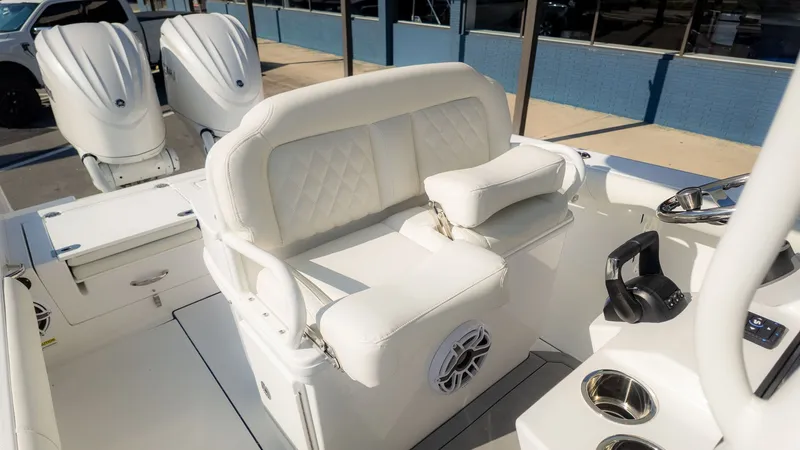 Slide: The Image of The image shows the cockpit of an Everglades 273 Center Console boat with white upholstery and controls. - 20