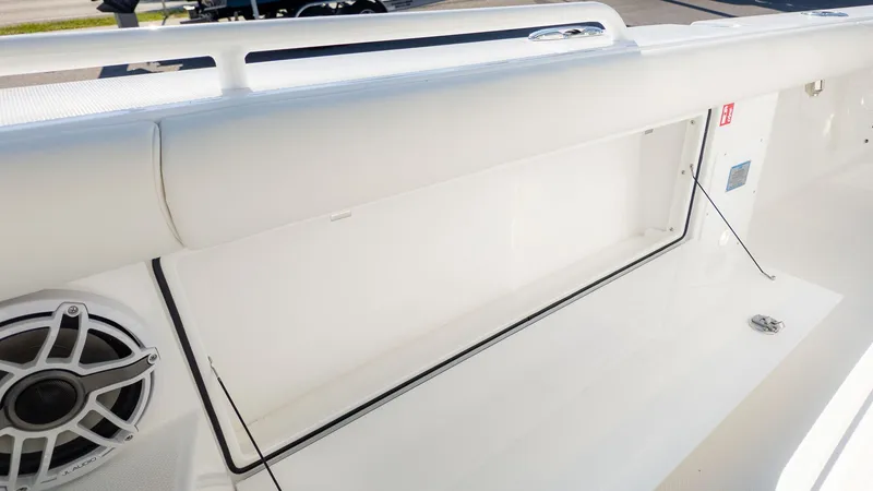 Slide: The Image of A white boat hull with a speaker and storage compartment. - 21