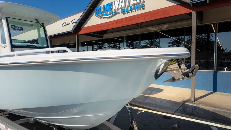 Slide: The Image of Everglades 273 Center Console from 2027 in front of a marine store. - 3