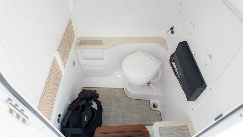 Slide: The Image of Interior of a boat cabin with a toilet and storage space. - 27
