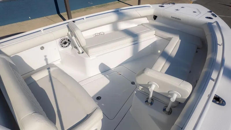 Slide: The Image of The image shows the cockpit of a 2027 Everglades 273 Center Console boat with white seating. - 22