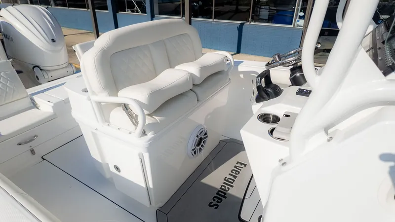 Slide: The Image of The image shows the cockpit of an Everglades 273 Center Console boat with white seating and controls. - 8