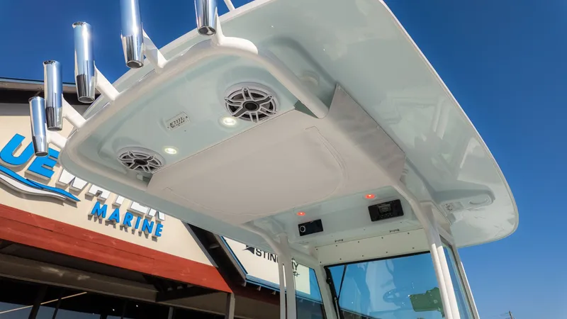 Slide: The Image of The image shows the roof of an Everglades 273 Center Console boat with speakers and lights. - 13