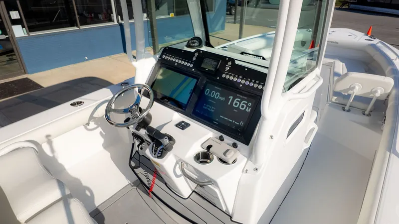 Slide: The Image of The image shows the cockpit of an Everglades 273 Center Console boat with modern electronics. - 17