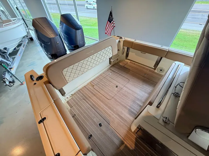 Slide: The Image of Interior of a Chris-Craft Catalina 30 Heritage Edition boat with wood flooring and beige seating. - 8