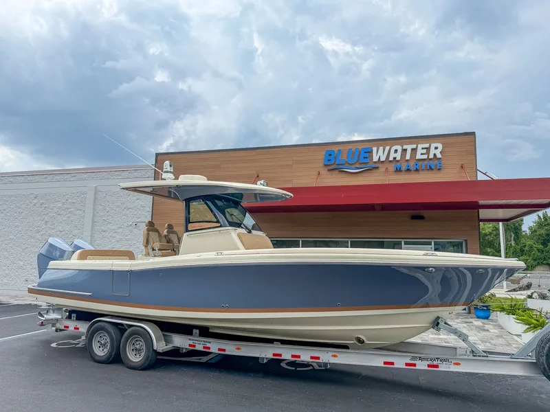 Slide: The Image of A 2024 Chris-Craft Catalina 30 Heritage Edition on a trailer in front of a building. - 17