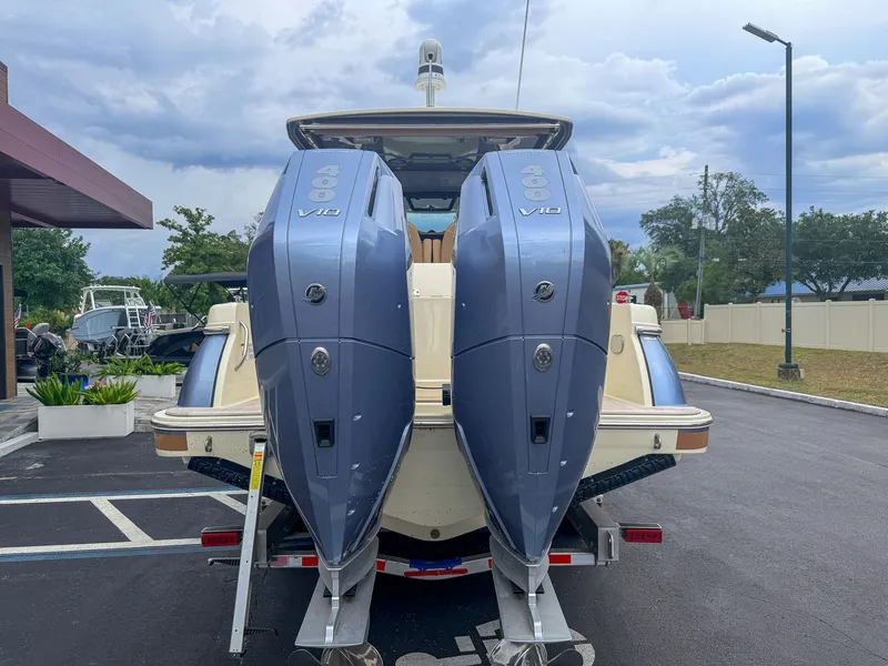Slide: The Image of Two large outboard engines on a Chris-Craft Catalina 30 boat on a trailer. - 14
