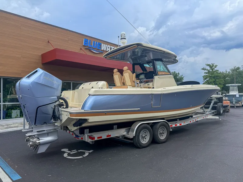 Slide: The Image of A 2024 Chris-Craft Catalina 30 Heritage Edition boat on a trailer in front of a building. - 22