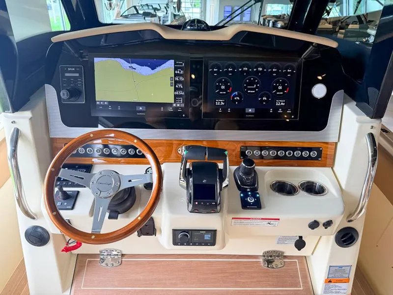 Slide: The Image of The cockpit of the 2024 Chris-Craft Catalina 30 Heritage Edition features a modern dashboard with wood accents. - 5