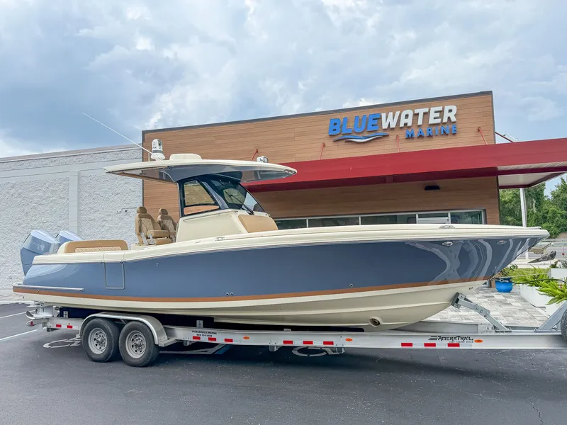 Slide: The Image of A 2024 Chris-Craft Catalina 30 Heritage Edition on a trailer in front of a building. - 21