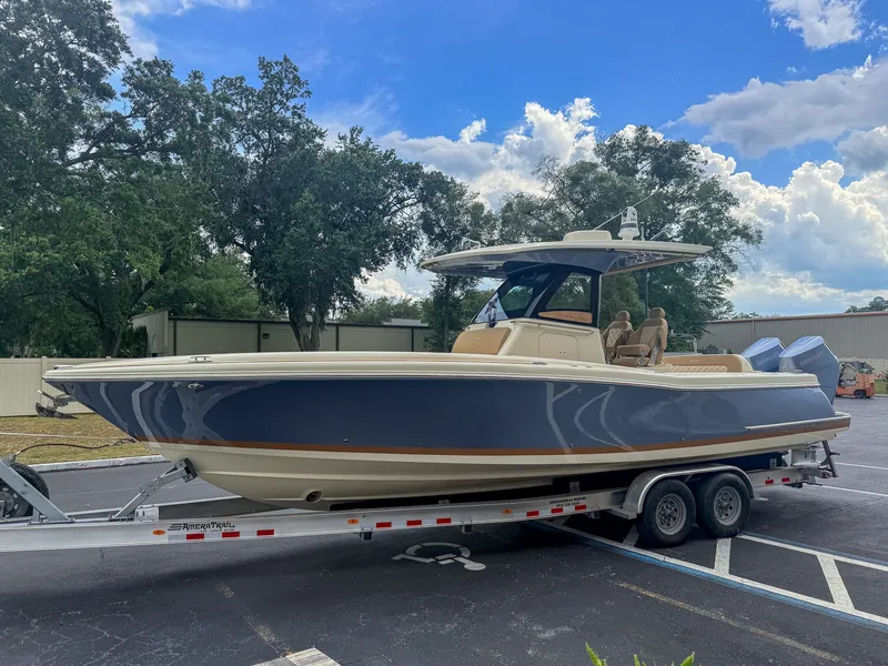 Slide: The Image of 2024 Chris-Craft Catalina 30 Heritage Edition on a trailer, surrounded by trees and buildings. - 20