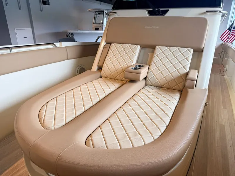 Slide: The Image of Luxurious lounging area with quilted leather and cup holder on a Chris-Craft Catalina 30 boat. - 9