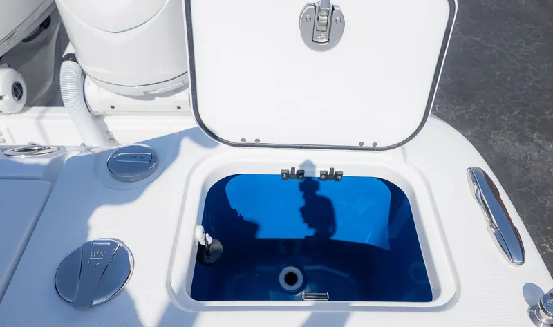 Slide: The Image of An open compartment on a boat with a blue interior and silver fittings. - 8