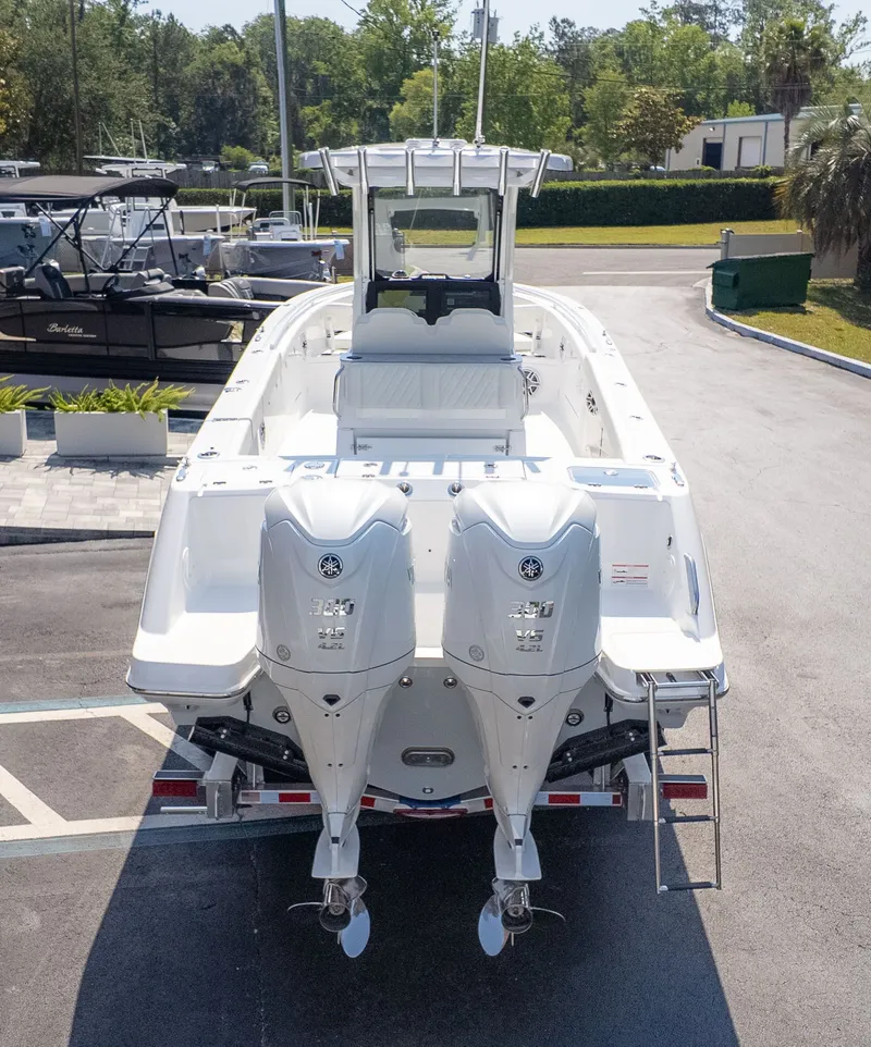 Slide: The Image of An Everglades 285 Center Console boat with twin outboard engines is parked on a lot. - 3