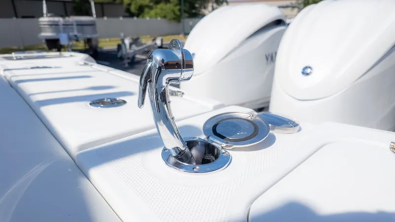 Slide: The Image of Close-up of a shiny metal handle on a white boat, surrounded by other boat parts. - 26