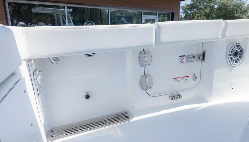 Slide: The Image of Close-up of the interior of an Everglades 285 Center Console boat with white upholstery and speaker. - 22