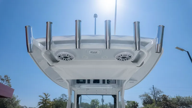 Slide: The Image of The image shows the roof of an Everglades 285 Center Console boat with rod holders and speakers. - 15