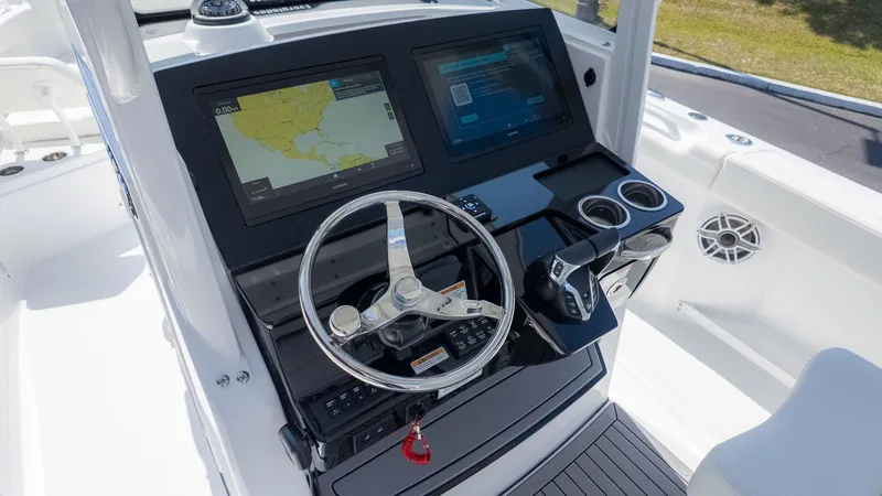 Slide: The Image of The image shows the helm of an Everglades 285 Center Console boat with modern navigation systems. - 18