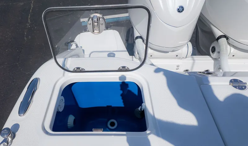 Slide: The Image of An open compartment on a boat with a blue interior and engines in the background. - 6