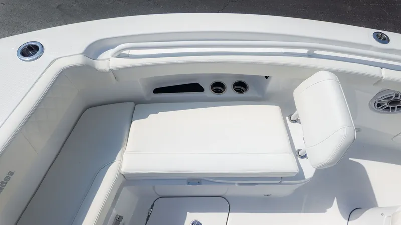 Slide: The Image of The image shows the seating area of an Everglades 285 Center Console boat with white upholstery. - 23