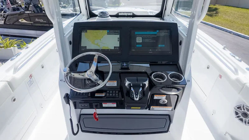 Slide: The Image of The image shows the helm of an Everglades 285 Center Console boat with modern navigation systems. - 18