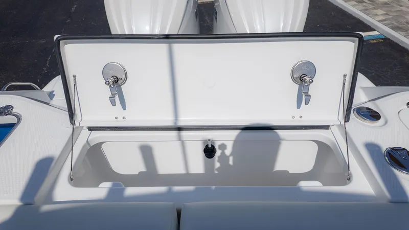 Slide: The Image of An open storage compartment on a boat with two latches. - 6