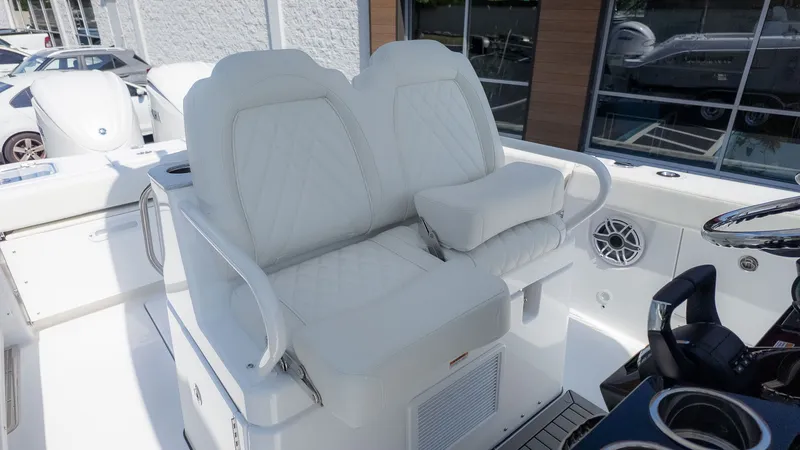 Slide: The Image of Two luxurious, cushioned seats on a boat with white stitching and armrests. - 19
