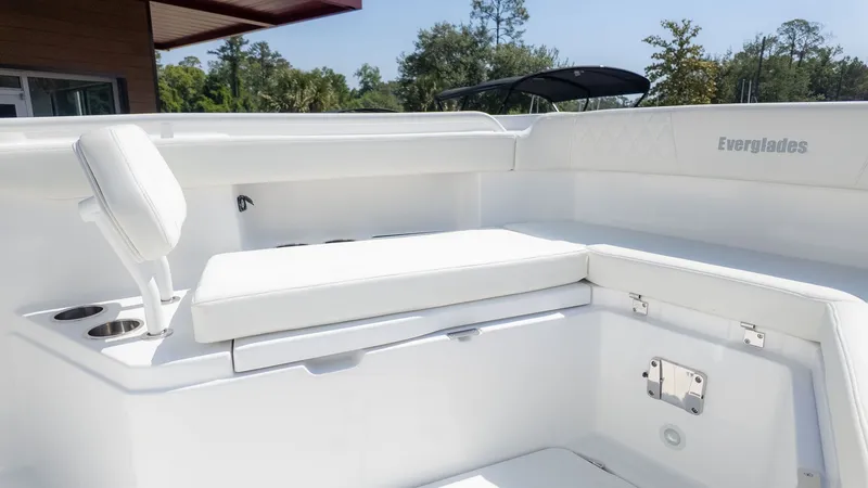 Slide: The Image of The image shows the cockpit of an Everglades 285 Center Console boat with white upholstery. - 9
