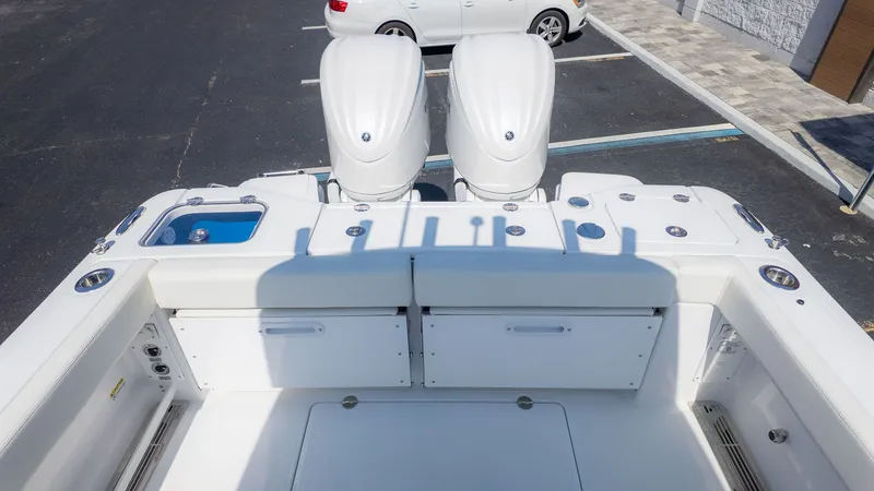 Slide: The Image of The image shows the stern of an Everglades 285 Center Console boat with two engines. - 3